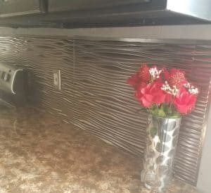 This DIY faux stainless steel backsplash is so easy to install, you won't believe it. Perfect for a kitchen remodel or for renters who need a removable stainless steel backsplash option.
