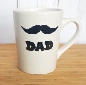 This moustache dad mug is a cute DIY Father's Day gift idea for guys. It's also an awesome present for Christmas, birthdays or Valentine's Day that kids can make. A simple tutorial and free printable templates to make your own homemade gift for coffee lovers. You don't have to be creative. Just grab some coffee cups at the dollar store and some Sharpie paint pens for a last minute gift idea.