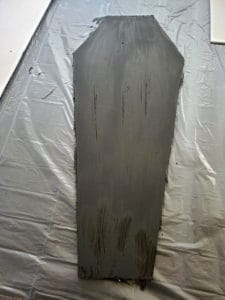 Coffin shape traced onto foam board with coffin template and painted black