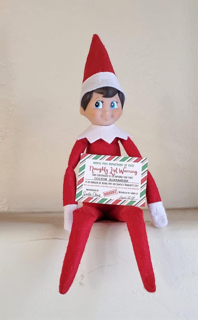 Elf On The Shelf holding mini naughty list warning certificate