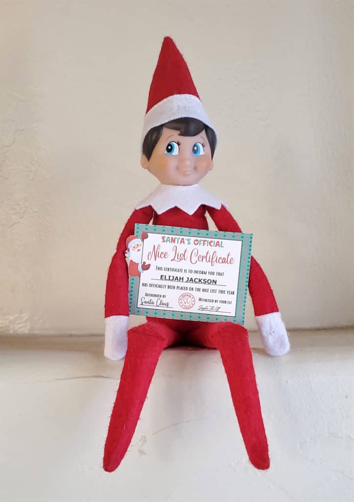elf on the shelf holding mini Santa nice list certificate