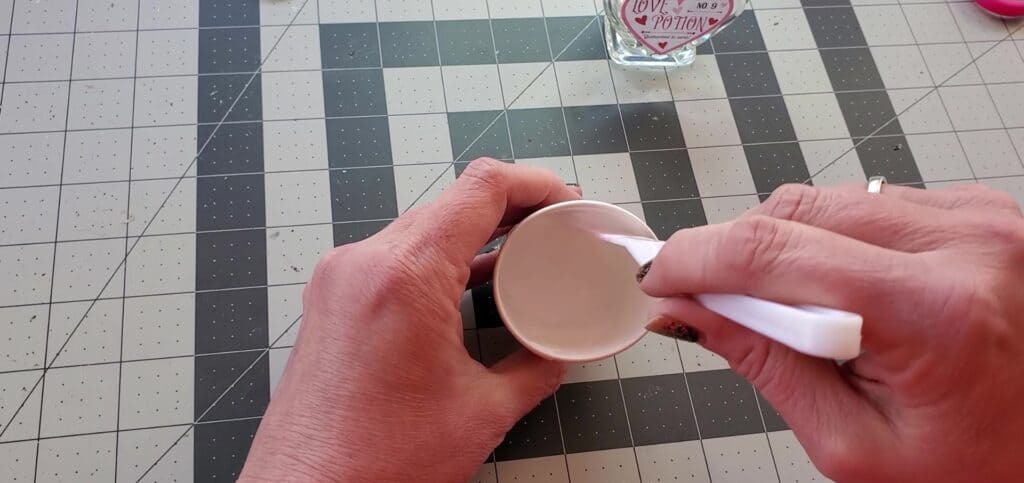 mix Mod Podge with water to coat the potion bottle