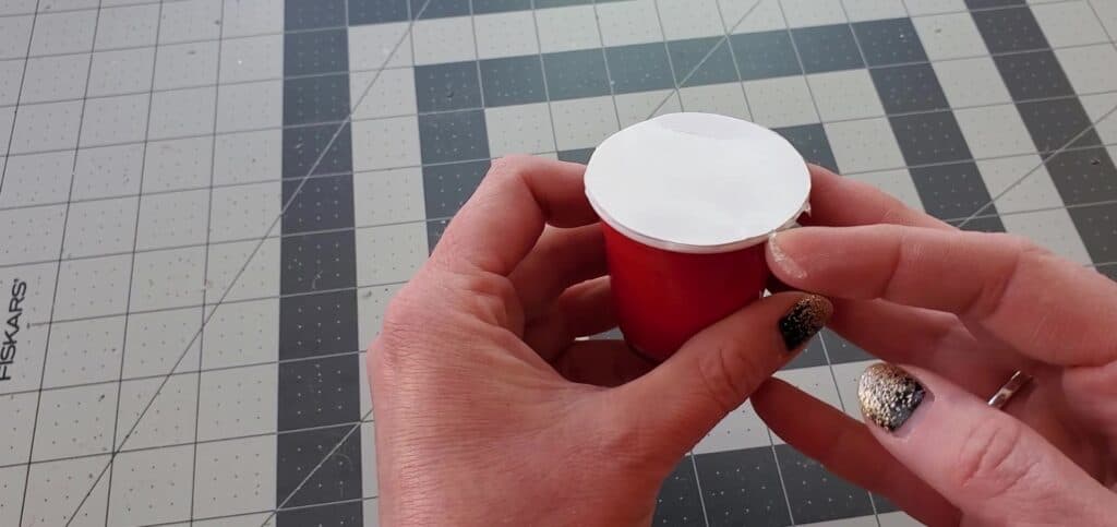 Press the circle onto the mini Starbucks cup