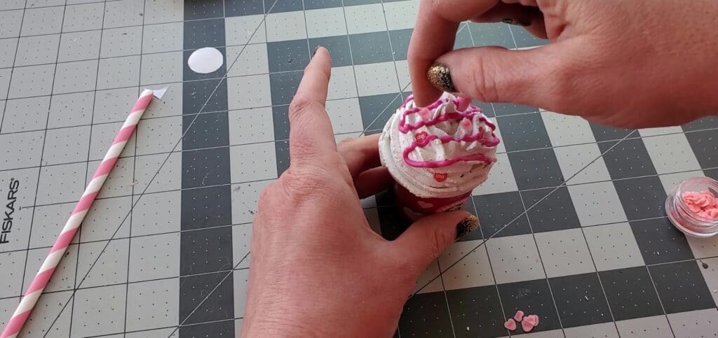 Add glitter and embellishments to the fake whipped cream