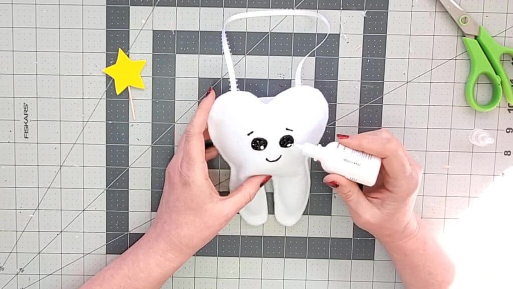 painting face on tooth fairy pillow