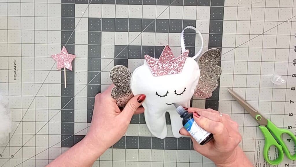 painting face on tooth fairy pillow
