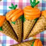 cupcakes baked in ice cream cone and decorated like carrots for a spring dessert or Easter treat for kids