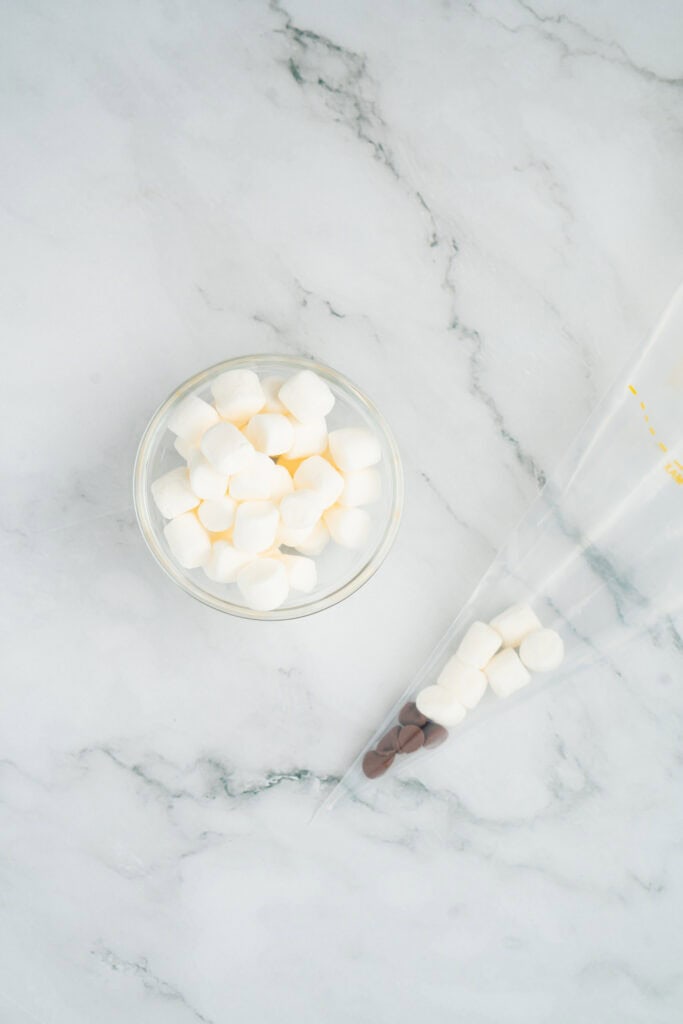 adding marshmallows to back to school goody bags